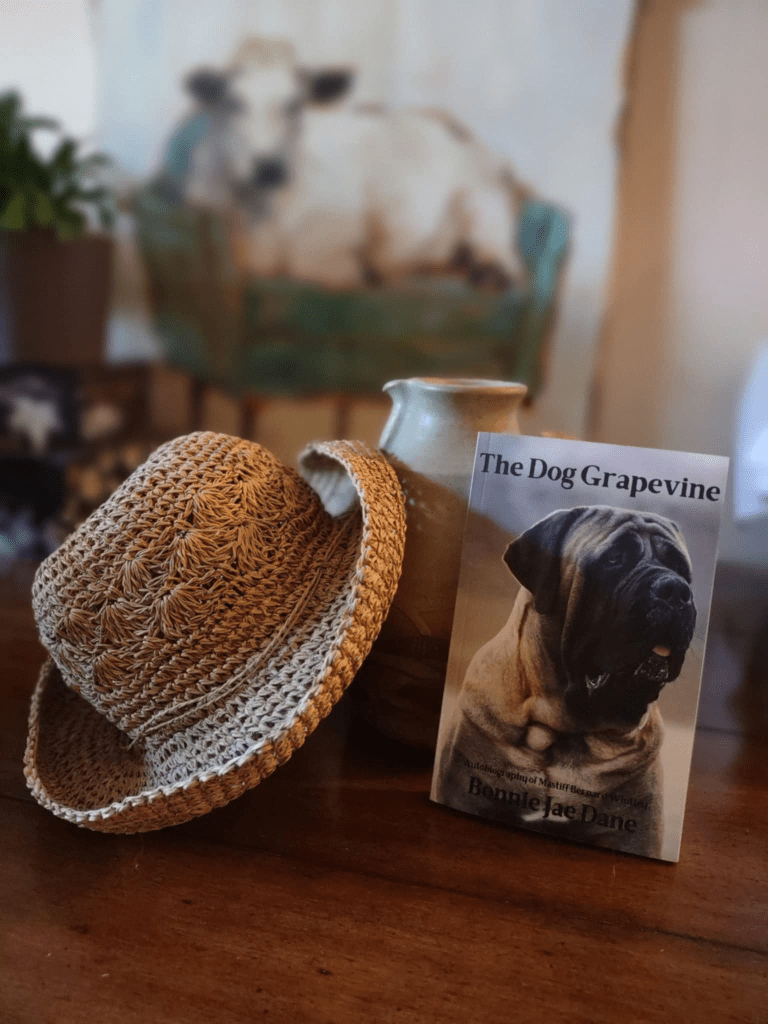 Paperback of The Dog Grapevine with a hat and jug