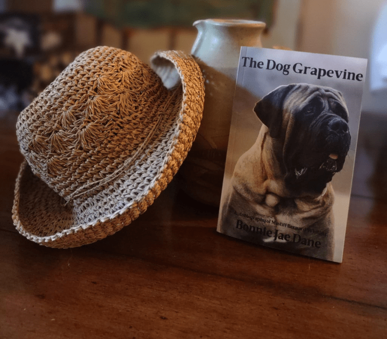 The book The Dog Grapevine by Bonnie Jae Danewith a straw hat